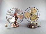 two small metal fans that are sitting on top of each other
