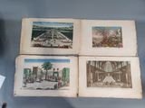 three old books with drawings on them sitting on a table
