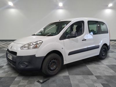 the small white van is parked in a large room