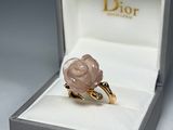 a ring with a rose on it sitting in a box