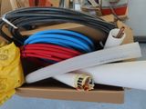a box with a bunch of different colored hoses in it