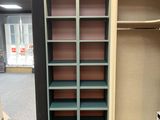 a large open book shelf in the corner of a room