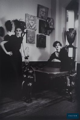 an old black and white photo of two women in a living room