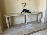 a cat that is sitting on a table in a room