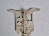 a picture of a metal badge with a bird on it