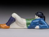 porcelain figurine of a woman laying down on her stomach
