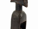 an old wooden figurine of a man with a helmet on it ' s head