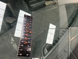 a ruler on the windshield of a car that is parked in a parking lot