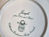 a white plate with a black and green design on it