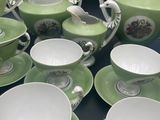 many cups and saucers sitting on a table