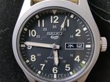 a close up of a watch on a black surface