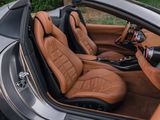 the interior of a sports car with leather seats and a steering wheel