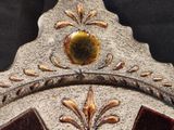 a close up of a clock with a decorative design on it