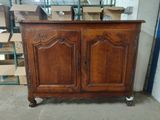 an old wooden cabinet in a warehouse with boxes in the background