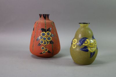 two vases sitting next to each other on a white surface