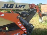 a crane that is sitting in the grass with a sign on it