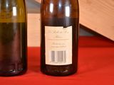 two bottles of wine sitting on a red table