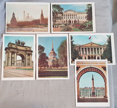 several old postcards of a building with a clock tower in the background