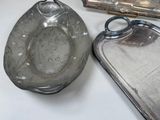 a silver plate and a silver tray on a table