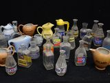 many different types of glass vases on a black table