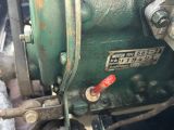 a close up of a green machine with a red button