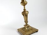 an antique brass candle holder on a white background with a white background