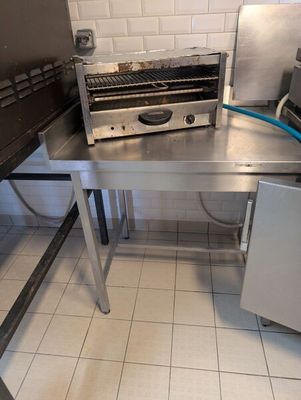 a toaster that is sitting on a table in a kitchen