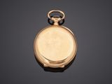 a close up of a gold pocket watch on a black surface