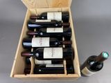 bottles of wine in a wooden box on a gray surface