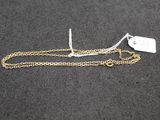 a close up of a gold chain with a tag on it
