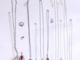 plusieurs types de colliers et de bagues posés sur un fond blanc