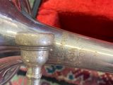 a silver trumpet sitting on top of a red chair