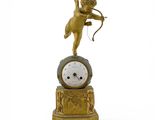 une horloge en or surmontée d'un Cupidon