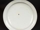an image of a white plate on a black background