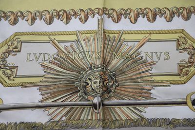 a drawing of a sword with a sunburst on it