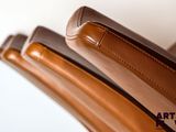 a close up of a pair of brown shoes on a chair