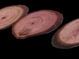 three slices of wood are shown on a black background