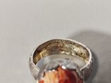 a silver ring with a piece of food in it