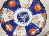 a blue and orange plate with a dragon on it