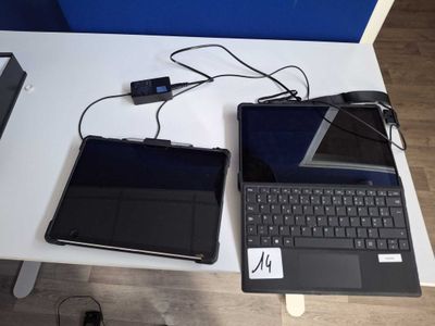 two laptops that are sitting on a table