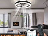 a person holding a remote control in front of a living room