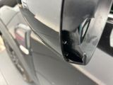 a close up of a car door handle with a hole in it