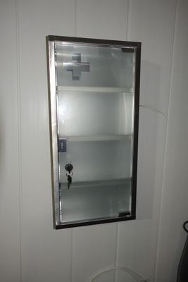 une petite armoire dans un coin d'une petite salle de bains
