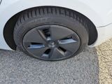 a close up of a tire on a white car