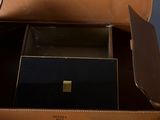 a brown briefcase with a black box inside of it