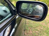 a side view mirror of a car that is outside