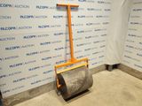 a floor roller in the middle of a room with a sign on the wall behind it
