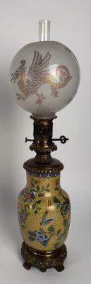 a lamp that is sitting on a stand with a bird on it