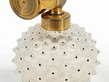 an old fashioned glass perfume bottle with a gold top and a brass handle