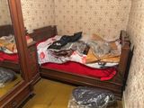 a bedroom with a bed and a mirror in it